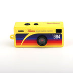 Front of the yellow G6 camera: lens, rainbow stripes and 1984 marking
